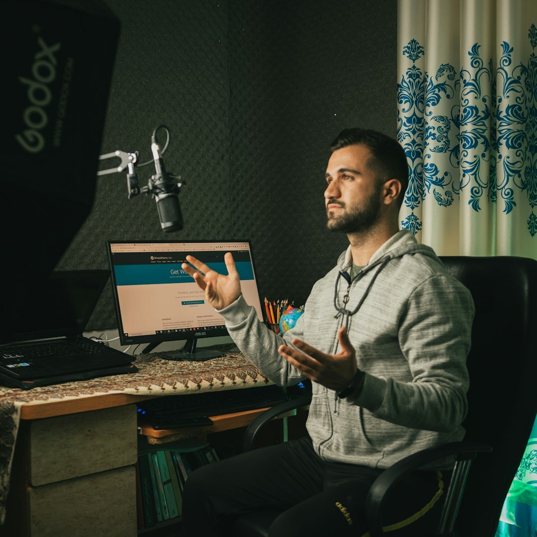 Audio engineer working at a sound mixing console with faders
